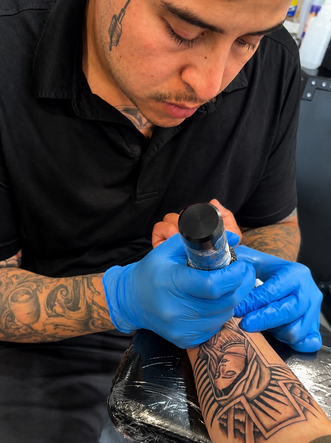 Cisco mid-session, tattooing a forearm piece in his Gilbert studio