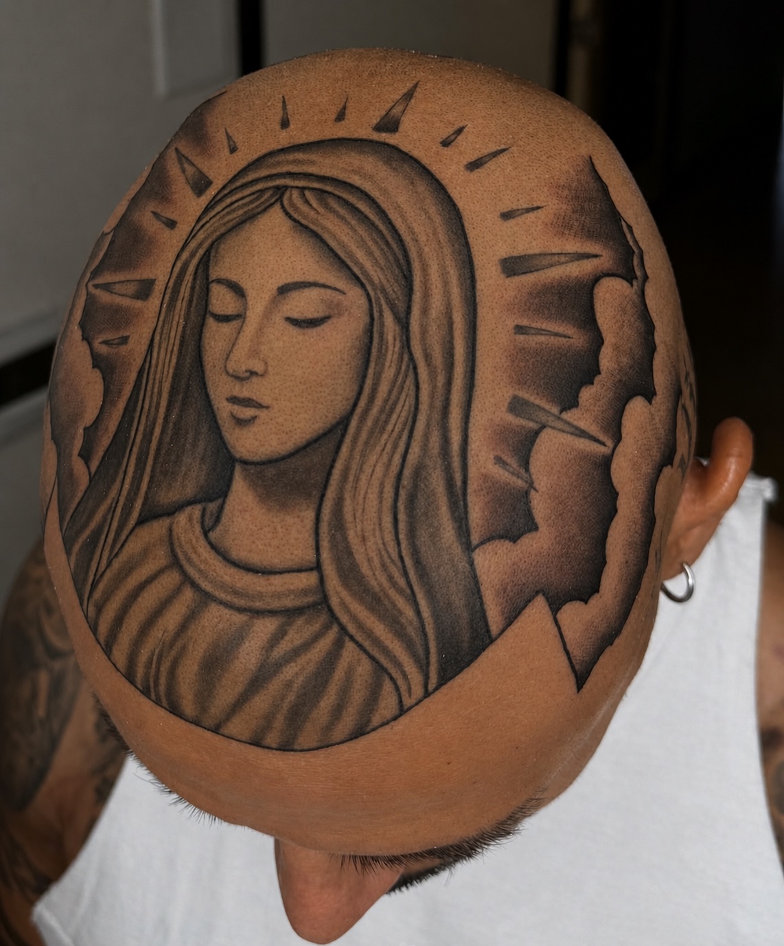 Virgin Mary head tattoo with halo and clouds — full scalp piece by Cisco