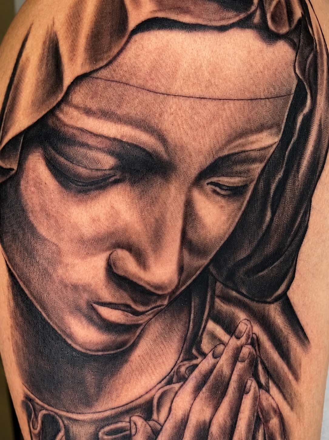 Black-and-grey realism tattoo of the Madonna in prayer — work by Cisco